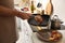 Man taking cooked tasty meat from frying pan, closeup