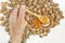 Man taking honey from a jar, walnuts and lemon