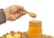 Man taking honey from a jar, walnuts and lemon