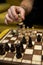 Man taking next step on chess game. Human hand moving wooden white chess king