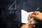 Man taking notes of math theorem on blackboard