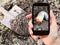 Man taking photo of larva of cockchafer in garden