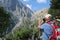 Man taking photo with mobile through while hiking on trail through Samaria gorge. (Crete, Greece).
