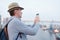 Man taking photo with mobile phone on the deck of cruise ship