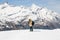 A man taking a photo with vintage film camera on the snow in the background of snow mountain.