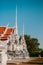 A man taking photo of Wat Uposatharam Temple or Wat Bot at noon