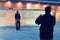 Man taking photo of woman at Iced wall in Rovaniemi