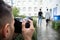 Man Taking Photograph Of Couple Walking Together At Outdoors