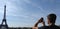 Man taking a photograph of Eiffel tower in Paris