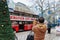 Man taking photos of City tour touristic bus on his mobile phone in Berlin, Germany