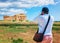 Man taking photos of Doric temple of Hera at Selinunte