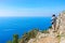 Man taking photos of Path of Gods at Tyrrhenian sea