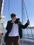 Man taking photos with professional camera when sailing on luxury sail yacht