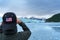 Man is taking a picture of Hubbard Glacier.