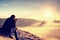 Man taking picture of landscape awaking in mist. Tourist with camera and tripod