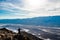 Man taking a picture on mobile phone at Dante`s View viewpoint on the North side of Coffin Peak, along the crest of the