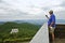 Man Taking a Picture of Mountains