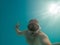 man taking selfie picture underwater in scuba mask