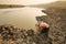 Man taking water from drying pond