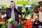 Man talking on mobile phone in greengrocery