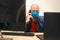 The man is talking on the phone in the office during quarantine. Virus protection at work. A specialist in a medical mask and a