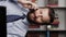 Man is talking on phone and smiling. Vertical view positive bearded man at workplace emotionally talking on phone and