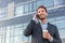 Man talking on smartphone. Businessman urban professional business man using mobile phone smiling drinking coffee at