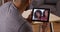 Man talking to relatives with tablet