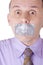 Man with taped mouth