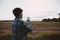 Man in tartan shirt photography your selfie, Turned against natural view, with the sunset light is beautiful sky on rice fields or