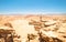 Man with tattoos hiking on rock formation at Atacama desert Chile