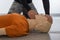 Man teaching cardiopulmonary resuscitation with a dummy on a white background. Front-chin manoeuvre