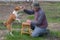 Man teaching cute basenji dog simple tricks