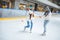 man teaching girlfriend how to skate