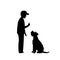 Man teaching his dog basic obedience command sit silhouette