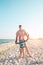 A man is teaching his son kitesurfing.