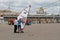 Man teaching woman how to ride skate with sail in the park Gorkogo