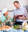 Man and teenager cooking together