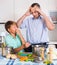 Man and teenager cooking together