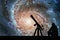 Man with telescope looking at the stars. Pinwheel Galaxy