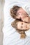 Man is telling fearful stories to his wife while they are lying on the bed