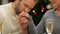 Man tenderly kissing woman hand, romantic date on Christmas night, closeup