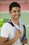 Man with on tennis court with tennis balls and racket portrait