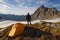 Man with tent observes the Alps