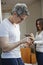 Man text messaging with his wife using a digital tablet