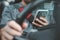 Man Texting while driving car. Irresponsible man Chatting and using smartphone. Writing and typing message with cellphone in vehic