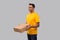 Man Three Pizza Box in Hands Watching Side Isolated. Yellow Tshirt Indian Delivery Boy. Man With Pizza in Hands