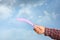 Man throwing boomerang against blue sky, closeup