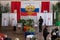 Man throws a ballot in an urn in the hall for voting in the Russian outback.