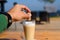 Man throws cubes of sugar cane in a mug of latte